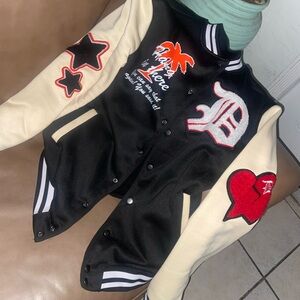 Black and Cream Varsity Jacket with Red and Orange Accents